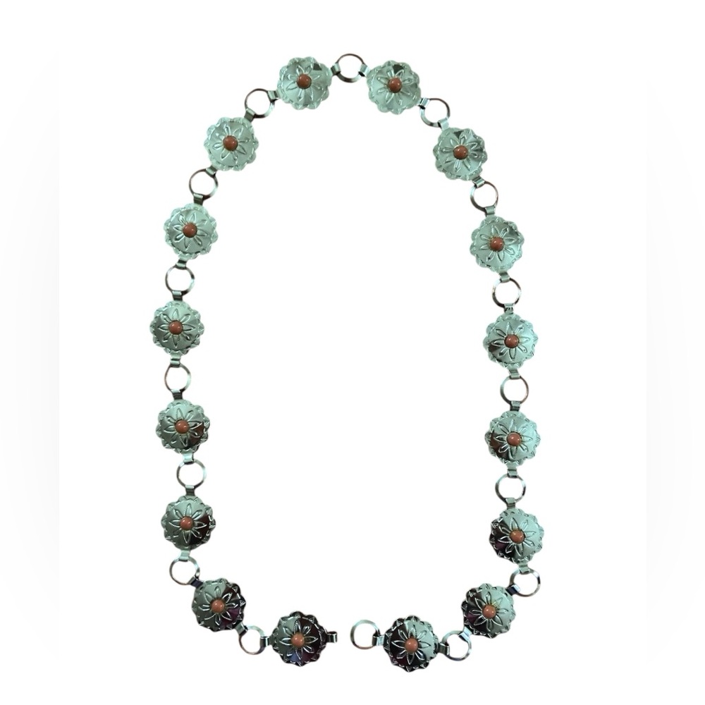 Southwest style Concho belt in silver with an orange trim.